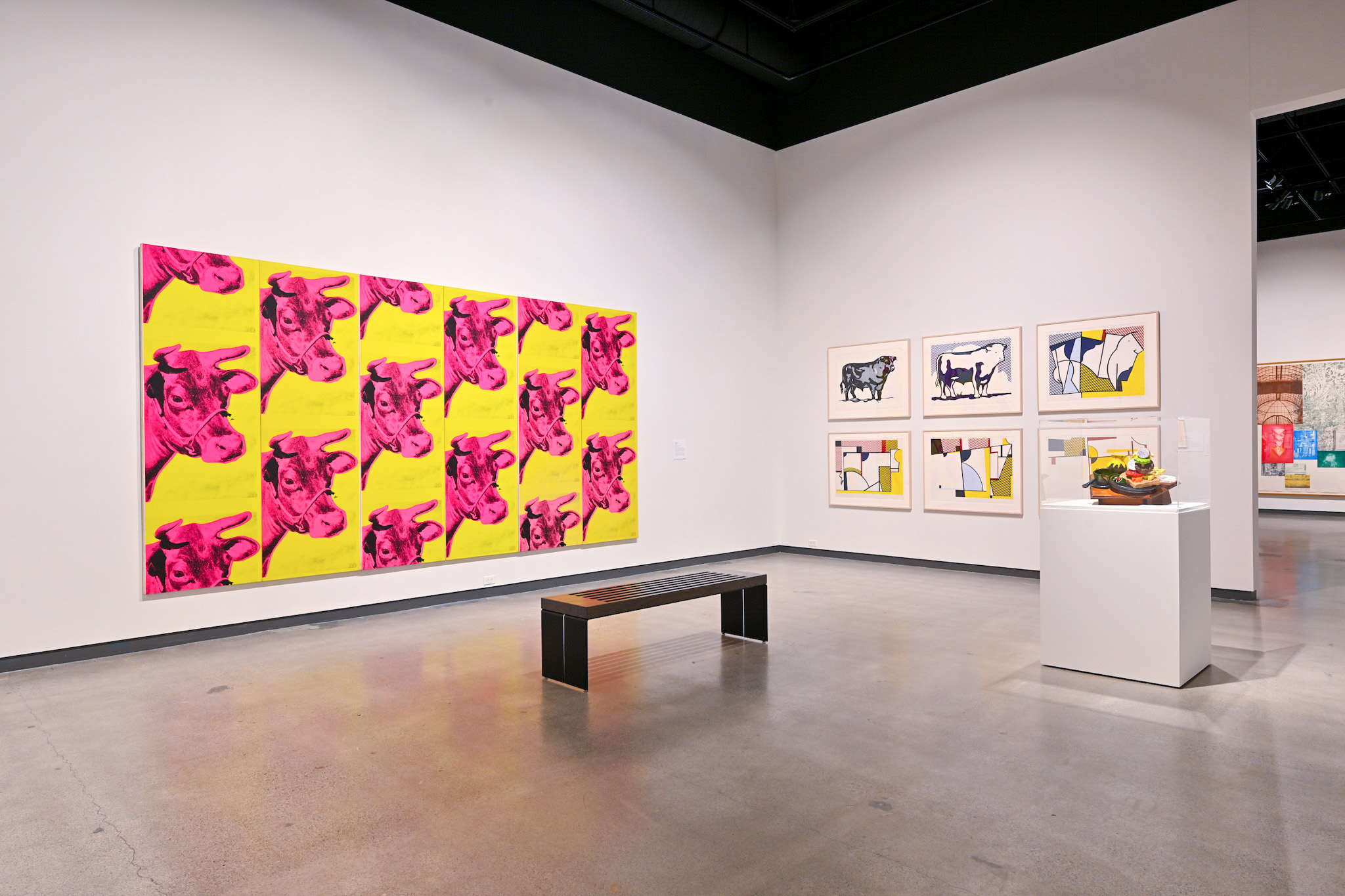 museum exhibition with artwork of cows and food