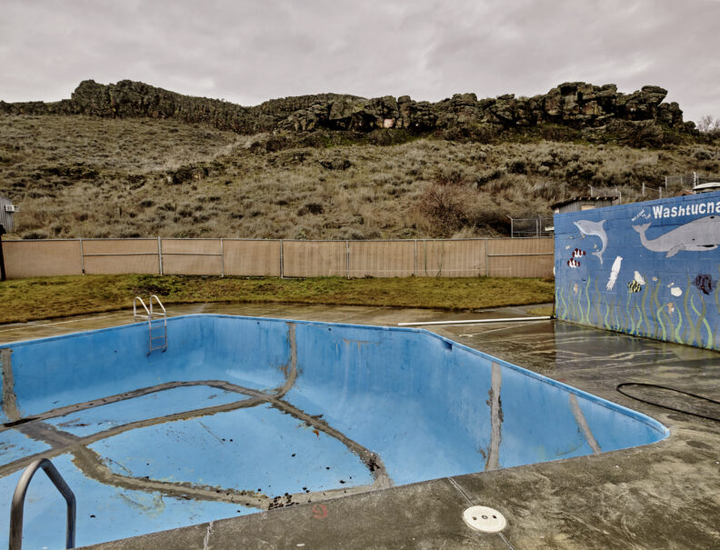 photo of an empty swimming pool set amidst a barren landscape