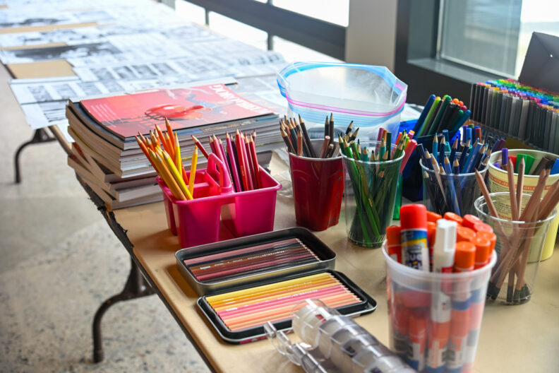 Image of tables with art supplies for making love letter zines