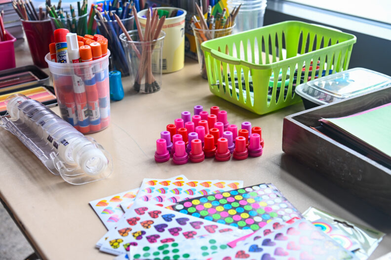 Image of tables with art supplies for making love letter zines