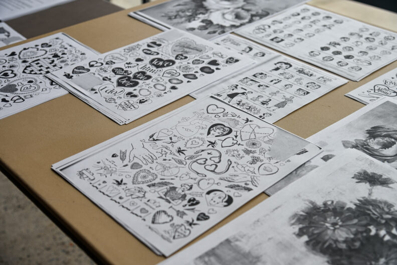 Image of tables with art supplies for making love letter zines