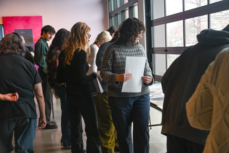 Image of participants standing in line to get supplies to begin making love letter zines