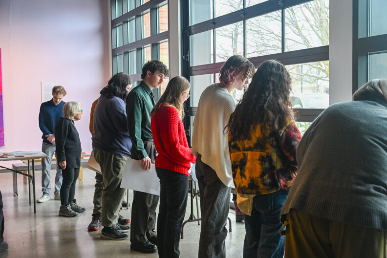 Image of participants standing in line to begin making love letter zines