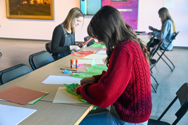 Image of workshop participants making collages in the museum