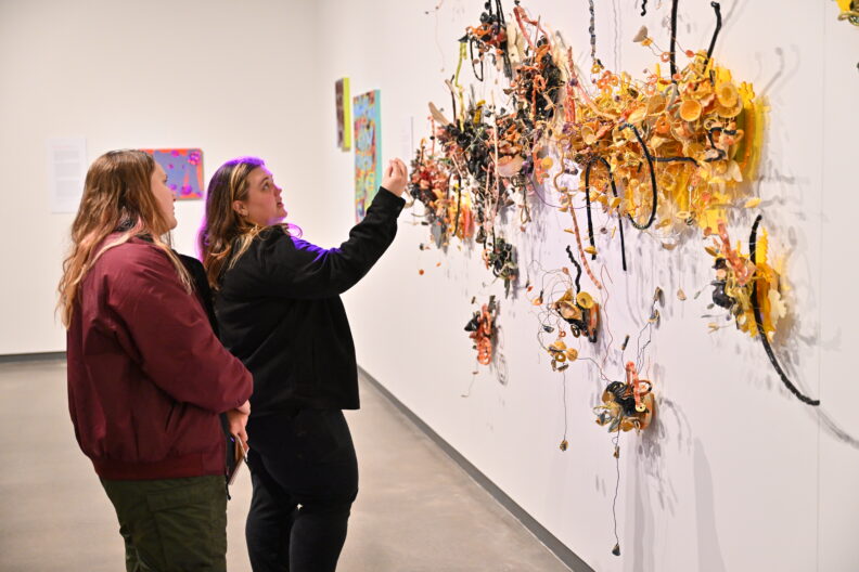 Image of museum visitors enjoying the Faculty Remix Exhibition Reception on 01/16/25