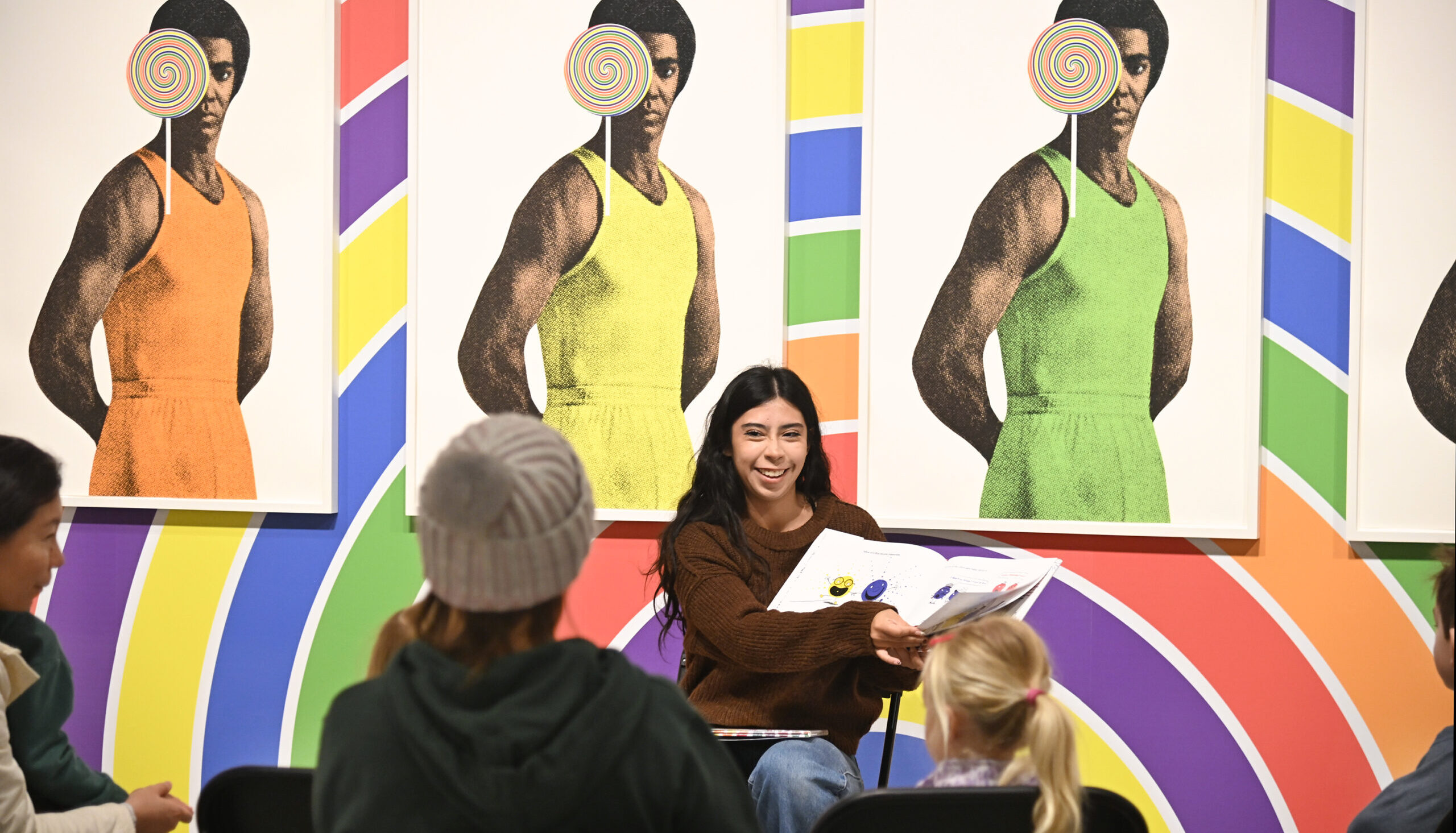 woman reading book to family