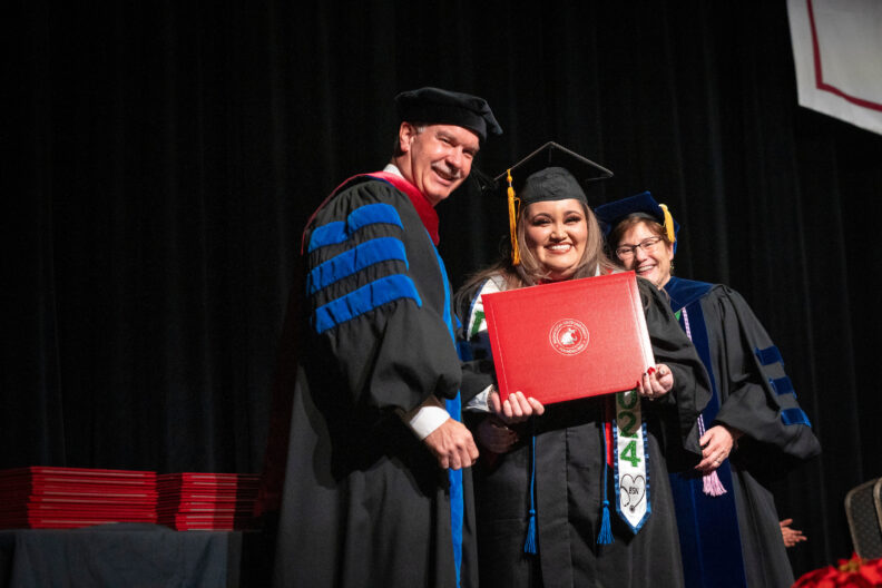 WSU Spokane Chancellor Daryll Dewald posing with a WSU College of Nursing graduate, Daizy Camargo, and Nursing Dean, Mary Koithan.