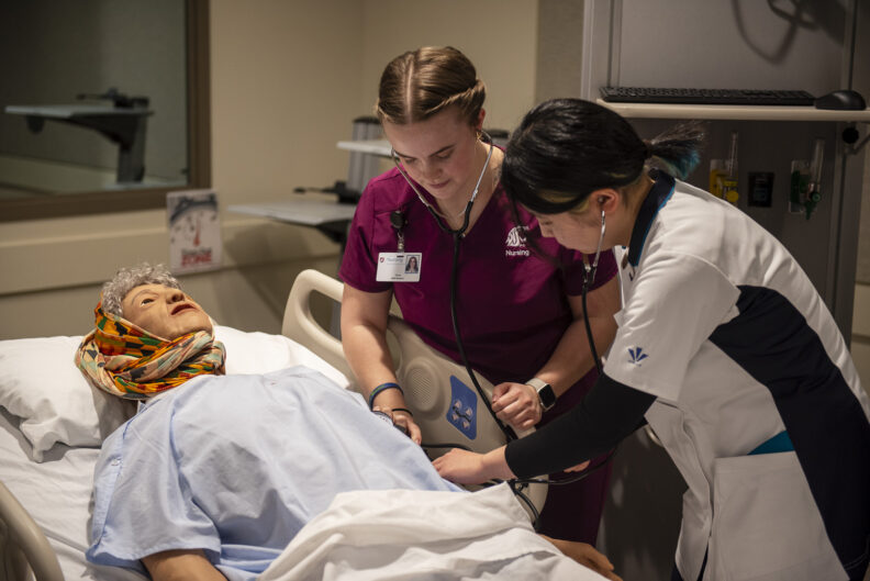 Greta G. '25 demonstrates taking vital signs from a manikin. 