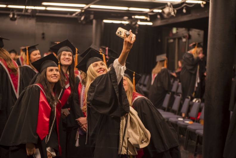 WSU College of Nursing graduates taking a selfie photo