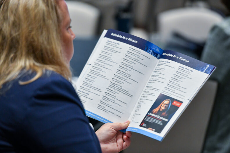 Sigma Congress attendee reviewing the program schedule.