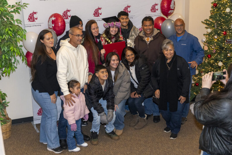 WSU BSN graduate with family, Fall class of 2025.