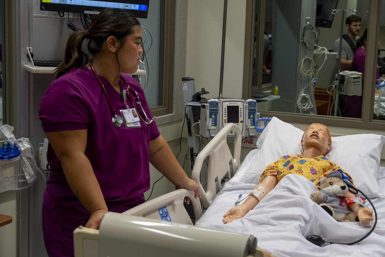 Nursing student attending to a manikin during simulation.