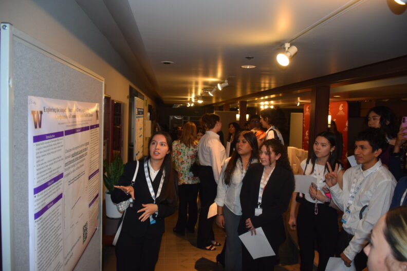 Student presenting a research poster.