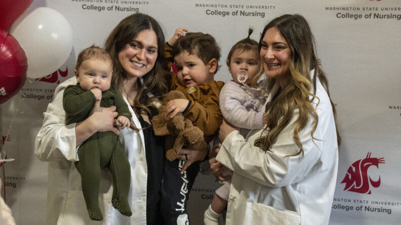 Kylie Flemens, BSN ‘24, RN and Kyra Nichols, BSN ‘24, RN with their children in their arms.
