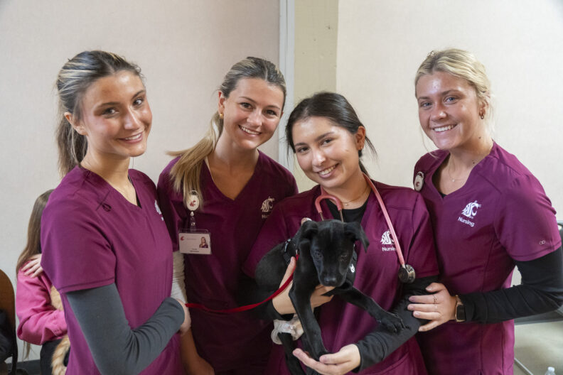Nursing students with a puppy at the recent Healthy People Healthy Pets event in Spokane, WA.
