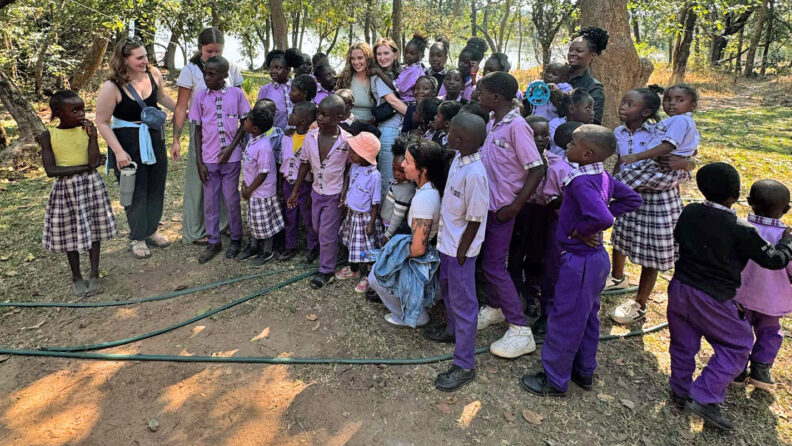 WSU College of Nursing students with a group of Zambian children on a school field trip. Photo: Greer Bainbridge.