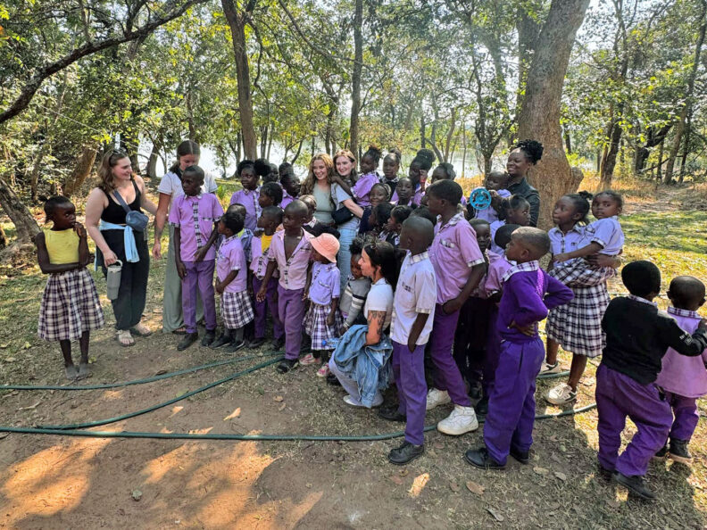 WSU College of Nursing students with a group of Zambian children on a school field trip. Photo: Greer Bainbridge.
