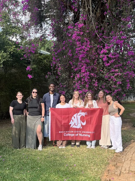 Nursing students pose with the Cougar flag on their first day in Zambia.