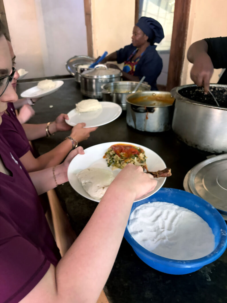 This is a picture of WSU students in line for a traditional Zambian meal called Nshima. Photo: Ryley Delima.