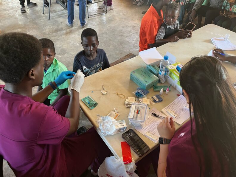 Nasir and Abby preparing blood samples at station 2. Photo: Eva Gill.