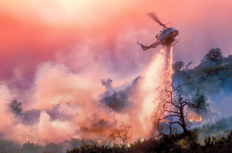 An aircraft attempts to put out a wildfire burning in California.