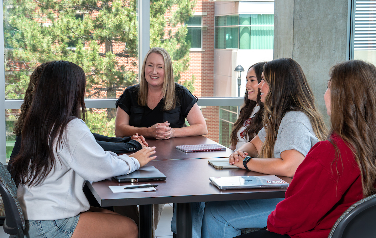 Dean Anne Mason speaking with a group of nursing students.