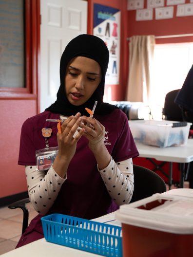 WSU College of Nursing nursing student, Shorooq Al Amri, drawing a vaccine dose. Photo: Brad Schwartz, WSU College of Nursing.