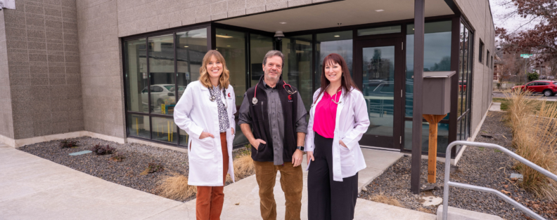 Sarah Fincham, Sam Schneider, and Leah Powell stand outside the WSU Health Logan Family Clinic.