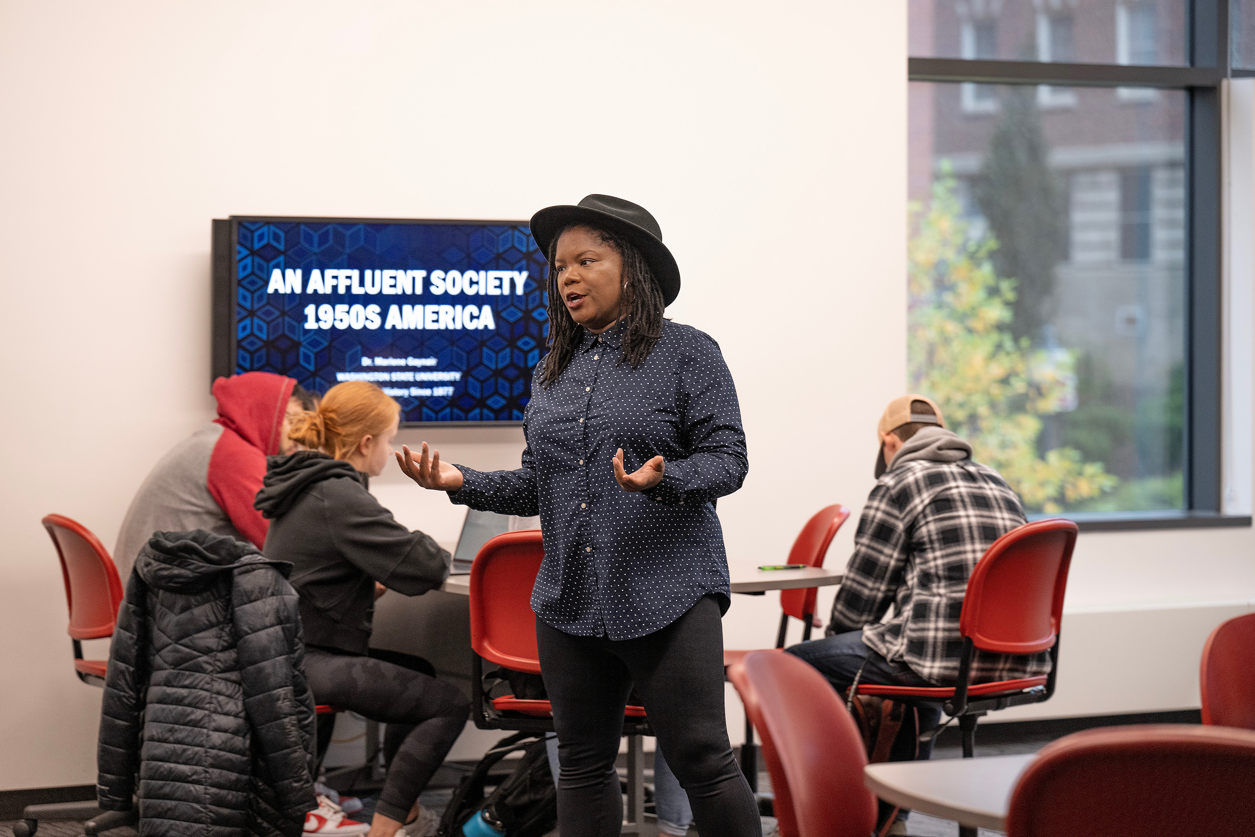 Students follow along with a History lesson on monitors while History Professor Marlene Gaynair lectures in classroom in the Spark building at WSU Pullman.