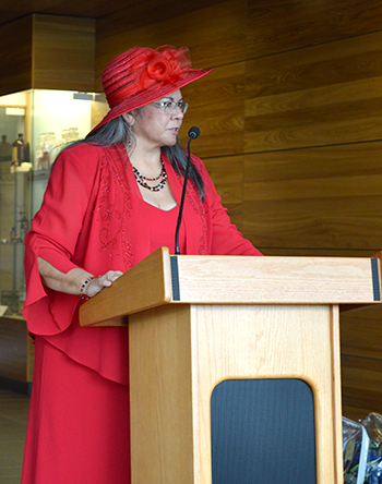 Dr. Robbie Paul addresses the crowd at her tea party-themed retirement party at WSU Spokane