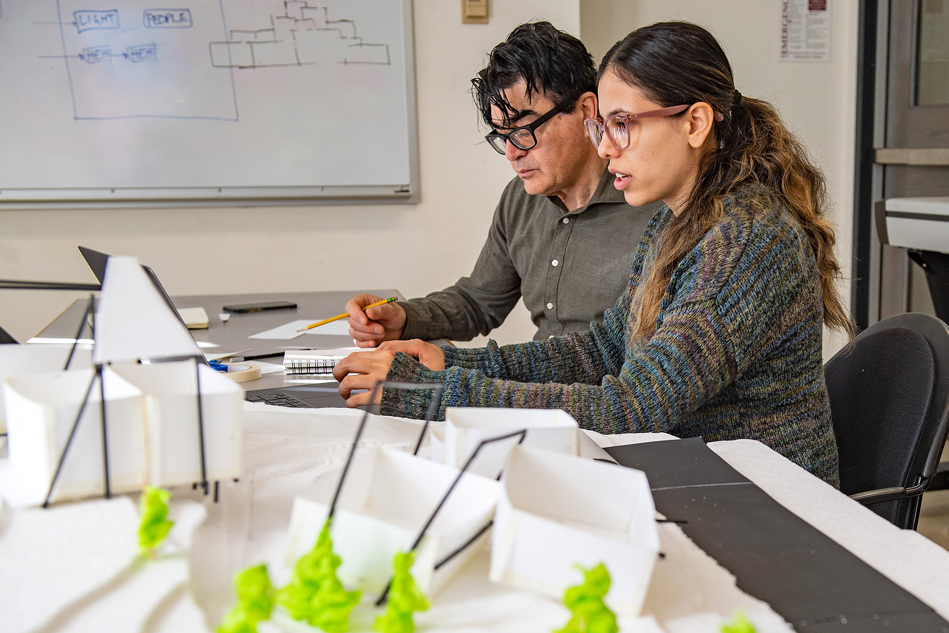 Architecture professor Ayad Rahmani works on a studio project with a student.
