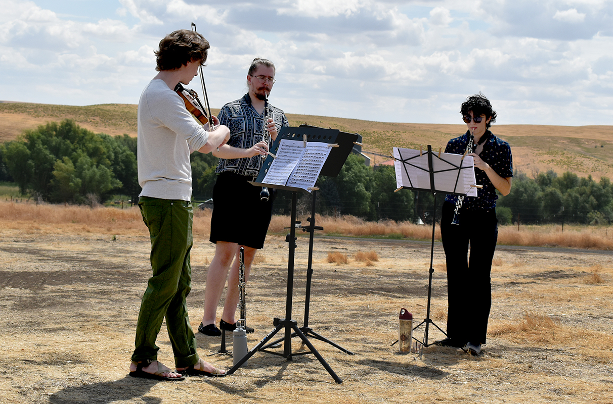 Alex Crisp, Kamil Tarnawczyk, and Calby Van Hollebeke perform on the Miller family farm in LaCrosse as part of the “Harvest Interludes” project.