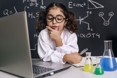 a scientist child looking pensively at a computer