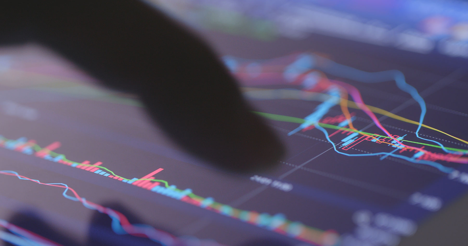 finger pointing at data charts