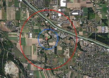 the same land area as is indicated in the map above. the red circle on the outside shows the extent with a smaller blue circle inside it, around a red location marker at the center.