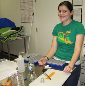 Girl with a rack of small sample tubes