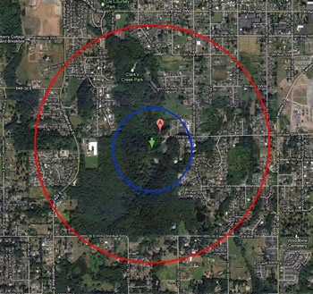 A smaller version of the previous map with a red circle indicating the full extent of the site. A smaller blue circle is around a green arrow (centered) and a red location marker. 