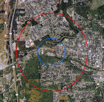 the same land area as is shown in the map above. the red circle on the outside shows the extent with a smaller blue circle inside it, around a red location marker at the center.