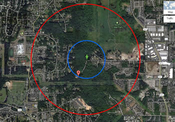 the same land area as is shown in the map above. the red circle on the outside shows the extent with a smaller blue circle inside it, around a red location marker at the center.