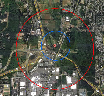the same land area as is shown in the map above. the red circle on the outside shows the extent with a smaller blue circle inside it, around a red location marker at the center.