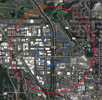 the same land area as is shown in the map above. the red circle on the outside shows the extent with a smaller blue circle inside it, around a red location marker at the center.