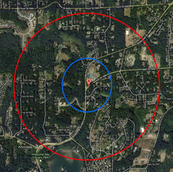 the same land area as is shown in the map above. the red circle on the outside shows the extent with a smaller blue circle inside it, around a red location marker at the center.