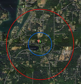 the same land area as is shown in the map above. the red circle on the outside shows the extent with a smaller blue circle inside it, around a red location marker at the center.
