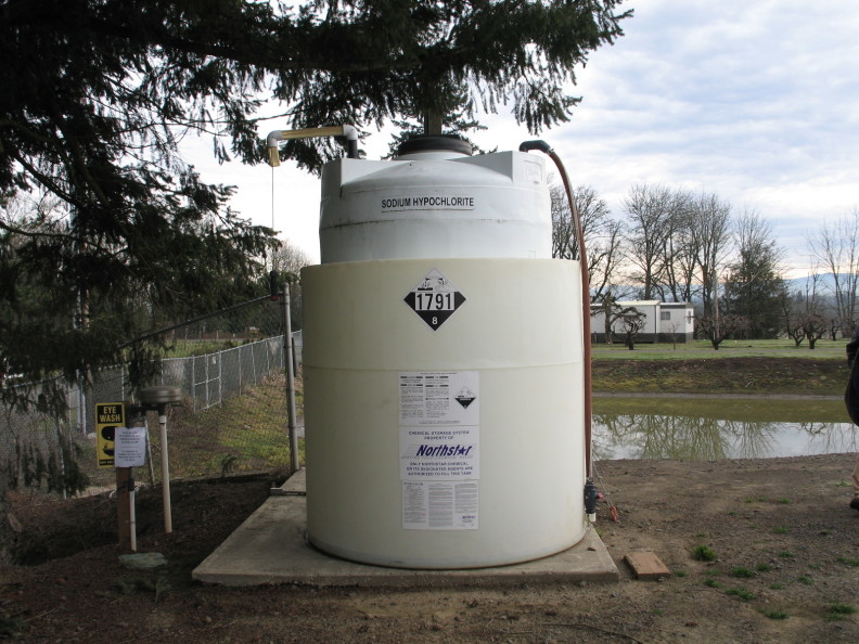 a large tank labeled "sodium hypochlorite" with the danger numbers 1791