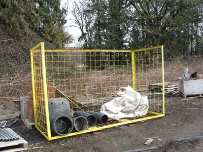 yellow open top and front wire container with used pots and soil bags