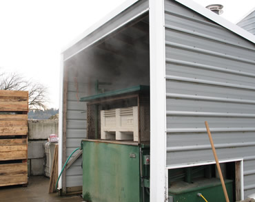 an open-front shed with a green machine for holding and maintaining hot water
