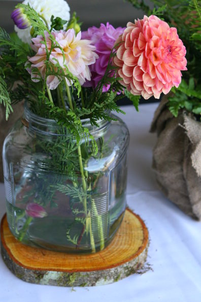cut flowers blooming in a square jar