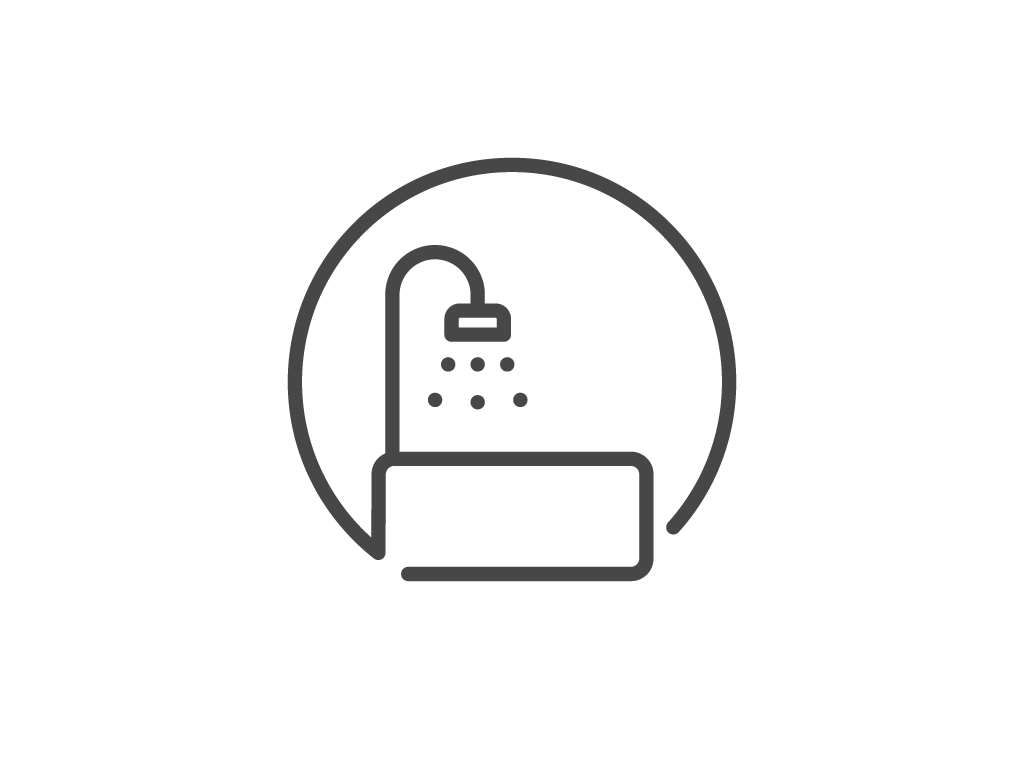 Simple line drawing of a bathtub with a shower head.