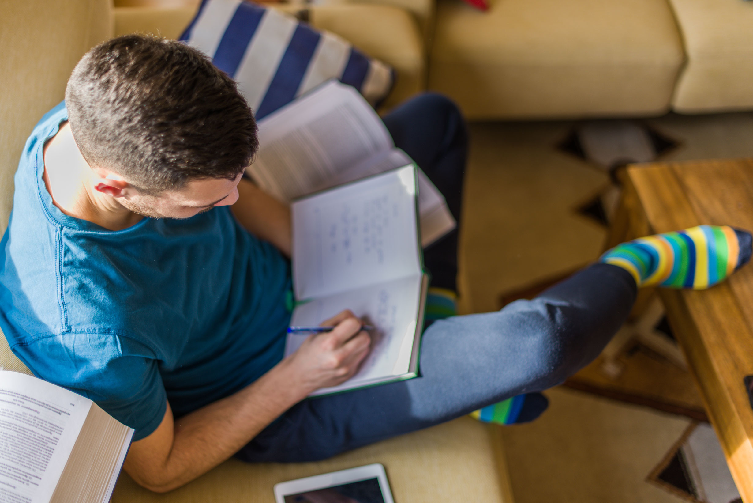 Stock image of a person writing in a notebook.