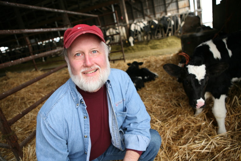 Dr. Joe Harrison with cows in background.